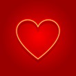 Neon heart on red gradient blurred background